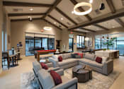 Thumbnail 4 of 87 - Clubroom with a large grey sofa and a coffee table.
