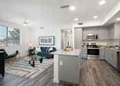 Thumbnail 39 of 87 - A modern kitchen with a dining area and a living room.