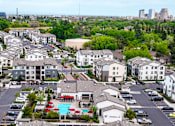 Thumbnail 74 of 85 - A large apartment complex with a pool in the middle.