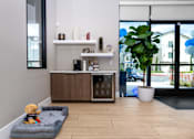Thumbnail 9 of 85 - leasing office with a dog plush on a bed and a shelf with decorative items.