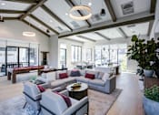Thumbnail 11 of 85 - Clubroom with a large grey sofa and a wooden coffee table.