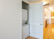 Thumbnail 93 of 104 - stackable washer and dryer in a laundry closet at The Grand Apartments, Oakland, CA