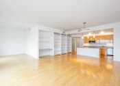 Thumbnail 94 of 104 - A large empty room with wooden floors and white walls at The Grand Apartments, Oakland 94612