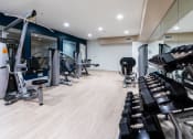 Thumbnail 4 of 59 - Fitness Center with Free Weights at The Preston Miracle Mile Apartments, California