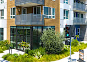 Thumbnail 124 of 137 - A modern building with a balcony and a traffic light.