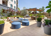 Thumbnail 118 of 137 - A patio with a table and chairs under a canopy.