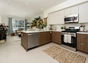 Thumbnail 31 of 137 - A modern kitchen with a large island and stainless steel appliances.