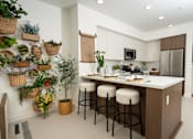 Thumbnail 28 of 137 - A kitchen with a white counter top and brown cabinets.