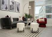 Thumbnail 7 of 137 - A living room with a black couch, a red chair, and a round table with a plant on it.