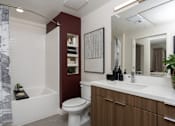 Thumbnail 21 of 137 - A white toilet sits next to a white sink in a bathroom.