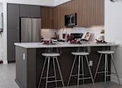 Thumbnail 1 of 137 - A modern kitchen with a white countertop and dark brown cabinets.