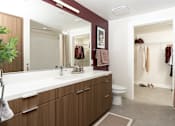 Thumbnail 13 of 137 - A bathroom with a white counter top and brown cabinets.