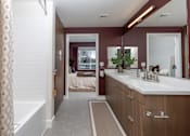 Thumbnail 5 of 137 - A bathroom with a white tub and a large mirror.