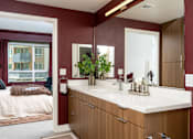 Thumbnail 12 of 137 - A bathroom with a white countertop and a brown cabinet.