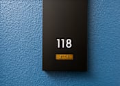 Thumbnail 33 of 137 - A black sign with the number 118 on it.