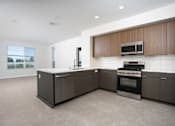 Thumbnail 35 of 137 - A modern kitchen with dark brown cabinets and a white countertop.