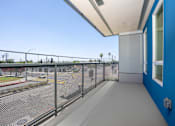 Thumbnail 37 of 137 - A view from a balcony overlooking a parking lot.