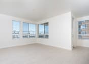Thumbnail 47 of 137 - A large empty room with white walls and wooden flooring.