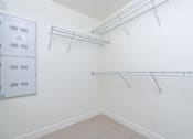 Thumbnail 40 of 137 - A white closet with a white door and shelves.