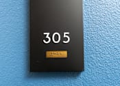 Thumbnail 52 of 137 - A black door plate with the number 305 on it.