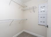 Thumbnail 73 of 137 - A white closet with a door and shelves.