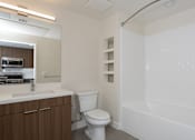Thumbnail 43 of 137 - A white toilet sits next to a sink in a small bathroom.