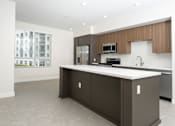 Thumbnail 57 of 137 - A modern kitchen with a large island and stainless steel appliances.