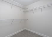 Thumbnail 76 of 137 - Empty room with white walls and grey carpet.