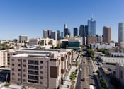 Thumbnail 19 of 26 - A cityscape with tall buildings and a clear blue sky at Wilshire Valencia Apartment, Los Angeles, CA, 90017
