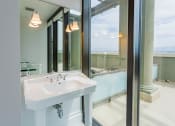 Thumbnail 35 of 44 - a bathroom with a white sink and a large mirror at Vendome Place, California 95110