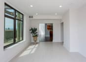 Thumbnail 37 of 44 - a large white room with a large window and a potted plant at Vendome Place, San Jose