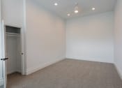 Thumbnail 36 of 44 - a empty room with white walls and carpet and a closet at Vendome Place, California