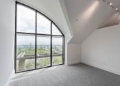 Thumbnail 38 of 44 - an empty room with large windows and a view of the city at Vendome Place, San Jose, California