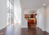 Thumbnail 40 of 44 - a living room with white walls and wood flooring and a kitchen at Vendome Place, San Jose, California