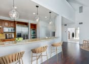 Thumbnail 32 of 44 - a kitchen with a bar and chairs in a house at Vendome Place, San Jose, CA 95110
