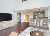 Thumbnail 31 of 44 - a living room and dining room with a television and a kitchen at Vendome Place, California 95110