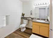 Thumbnail 33 of 44 - a bathroom with a toilet and a sink and a mirror at Vendome Place, San Jose, CA