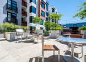 Thumbnail 6 of 51 - Outdoor Grill Area Surrounded by Lounge Seating, Tables, and Landscaped Grounds at Venue, San Francisco, CA, 94158