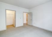 Thumbnail 21 of 51 - the living room and bedroom of an apartment with white walls and carpet at Venue, San Francisco, CA