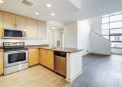 Thumbnail 30 of 51 - an empty kitchen with wood flooring and a large window at Venue, San Francisco, 94158