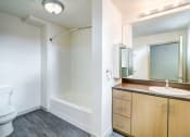 Thumbnail 36 of 51 - Bathroom with a Toilet, a Sink, a Shower, a Mirror, and Hardwood-Style Flooring at Venue, San Francisco, California