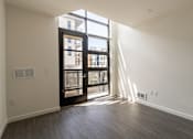 Thumbnail 47 of 51 - A room with a sliding door leading to a balcony.