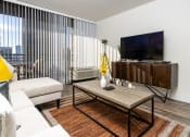 Thumbnail 13 of 39 - livingroom with seating, flat screen TV, entertainment center and large windows at Vera Cortez Hill, San Diego, California
