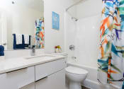 Thumbnail 21 of 39 - a bathroom with a shower curtain and a sink and a toilet at Vera Cortez Hill, San Diego, CA, 92101