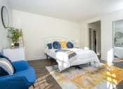 Thumbnail 17 of 39 - Bedroom wtih bed, blue chair, a large rug and mirror on the wall at Vera Cortez Hill, San Diego
