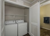 Thumbnail 11 of 25 - Washer and Dryer Inside Closet with Shelving at 55+ Remington at Ladera Ranch, California, 92694