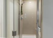 Thumbnail 25 of 34 - a shower with a glass door in a bathroom at Waterford RiNo, Colorado