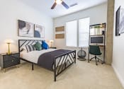 Thumbnail 21 of 34 - a bedroom with a bed and a ceiling fan at Waterford RiNo, Denver, CO 80216
