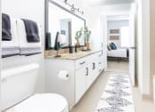 Thumbnail 24 of 34 - a white bathroom with a large mirror and a white toilet at Waterford RiNo, Colorado 80216