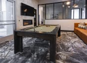 Thumbnail 7 of 34 - a pool table in the clubroom with a firepit at Waterford RiNo, Colorado
